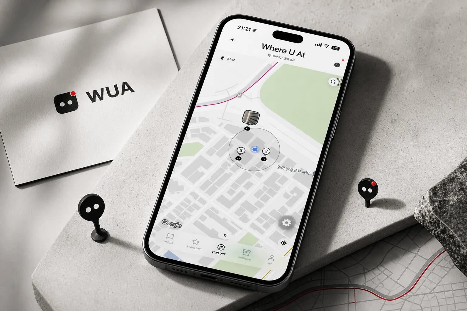 A phone showing the Where U At map, next to a WUA logo card